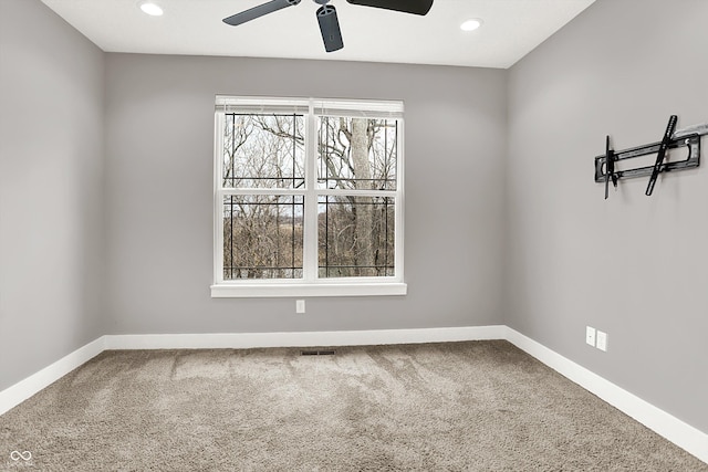 carpeted spare room featuring a ceiling fan, recessed lighting, visible vents, and baseboards