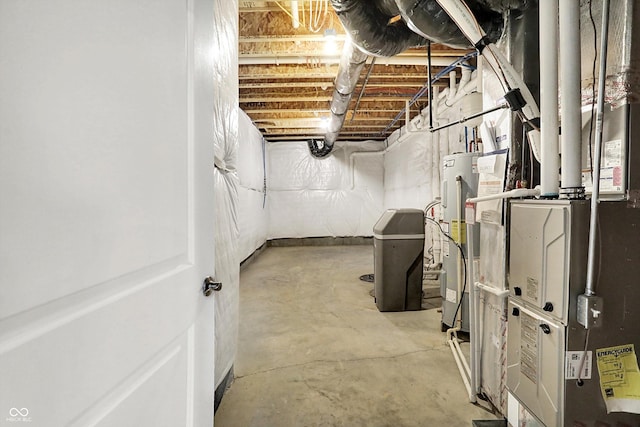 unfinished basement featuring heating unit and electric water heater