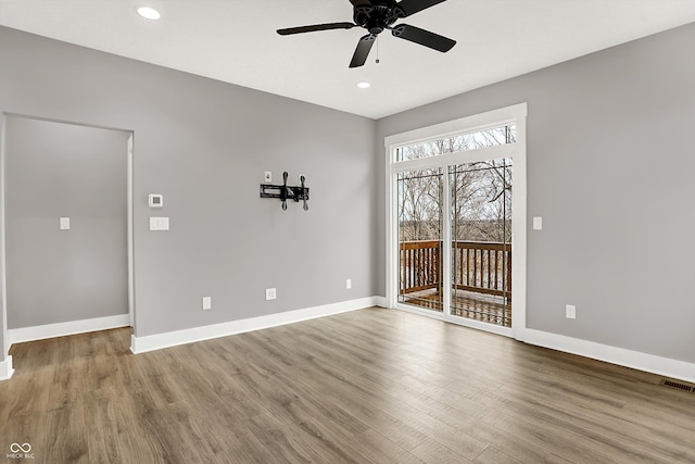 spare room featuring recessed lighting, visible vents, baseboards, and wood finished floors