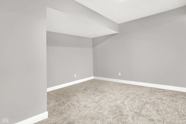 unfurnished room featuring carpet floors and baseboards