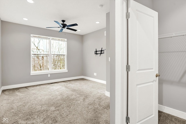 carpeted empty room featuring visible vents, baseboards, a ceiling fan, and recessed lighting