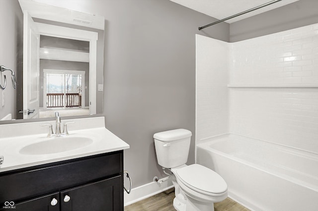 full bathroom featuring shower / bath combination, toilet, vanity, wood finished floors, and baseboards