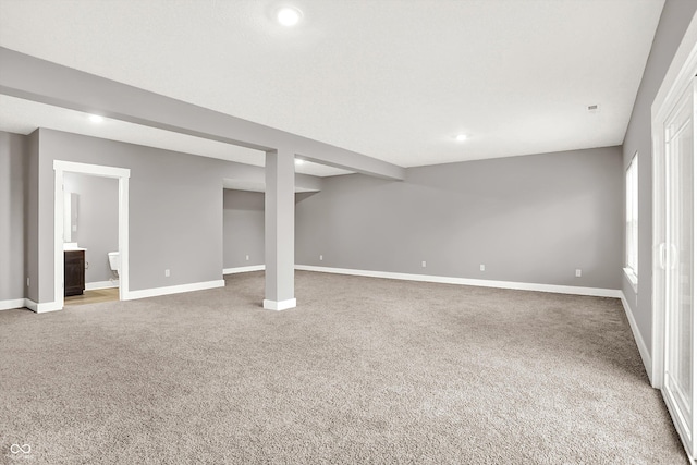 below grade area with recessed lighting, carpet, and baseboards