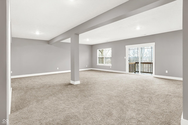 below grade area featuring carpet flooring and baseboards