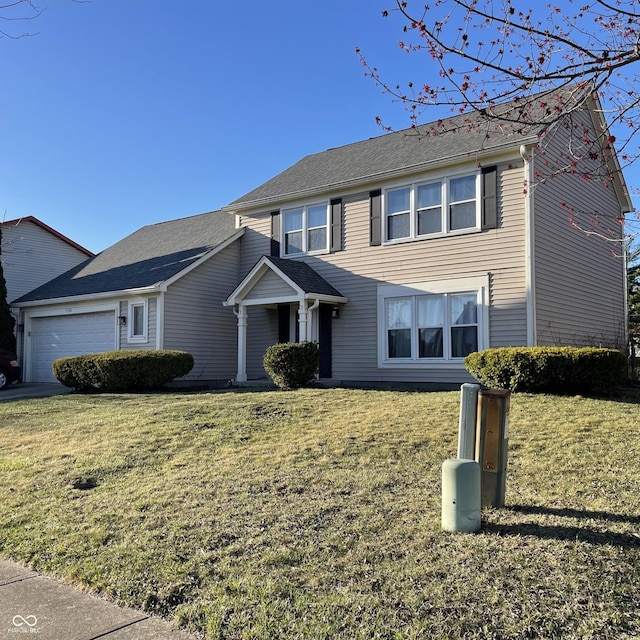 view of front of property featuring a front lawn and an attached garage