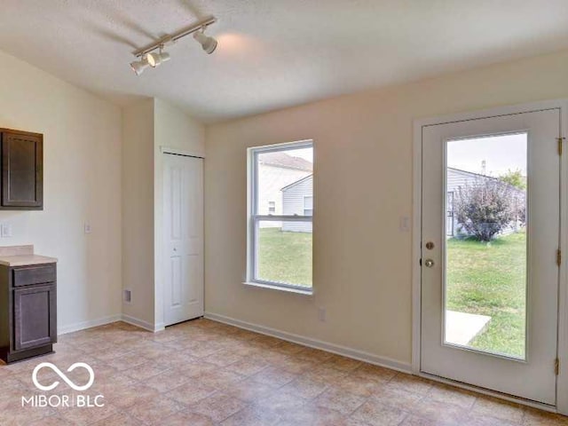 interior space featuring baseboards and a wealth of natural light