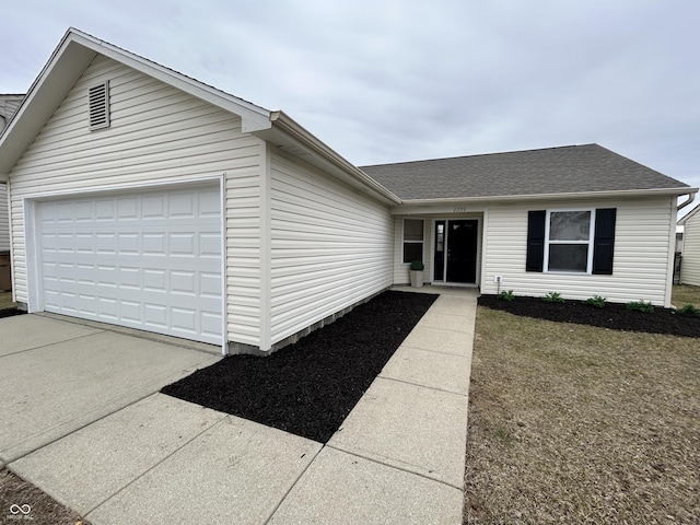 ranch-style house with concrete driveway, a shingled roof, and an attached garage