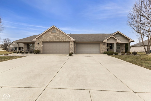 ranch-style home featuring brick siding, driveway, an attached garage, and roof with shingles