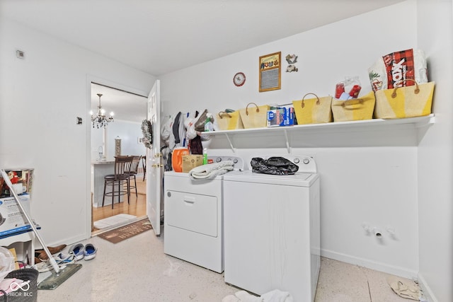 laundry room featuring laundry area, baseboards, visible vents, washer and clothes dryer, and a chandelier