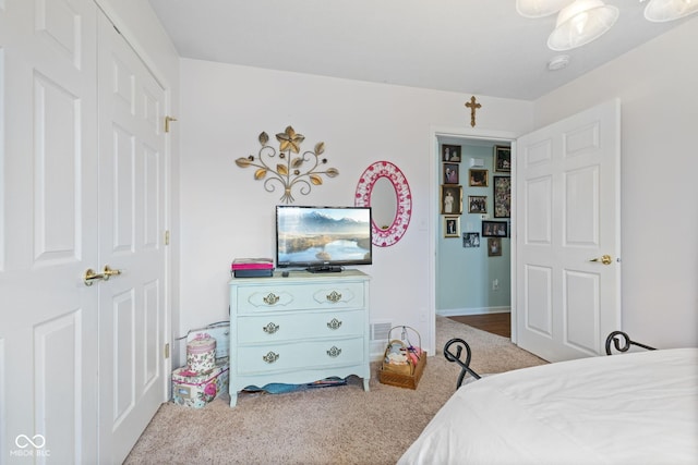 carpeted bedroom featuring visible vents