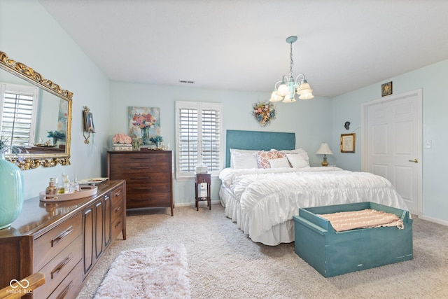 bedroom featuring baseboards, an inviting chandelier, visible vents, and light colored carpet