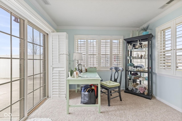 carpeted office space featuring baseboards, visible vents, and crown molding