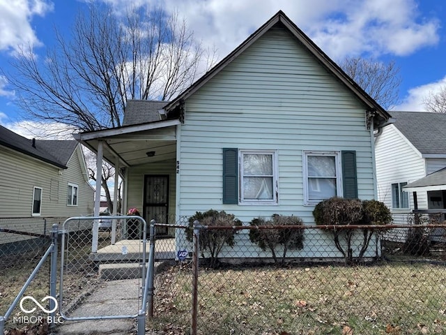 view of front of house featuring covered porch, a fenced front yard, and a gate