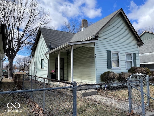 view of property exterior with a fenced front yard, a chimney, and roof with shingles