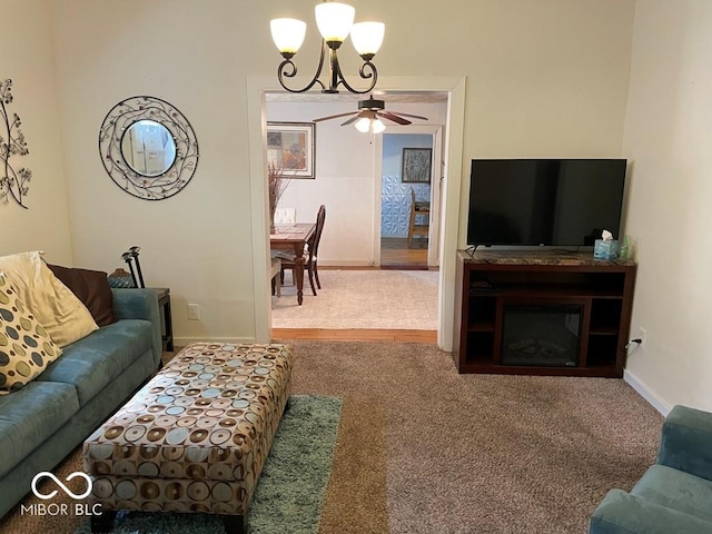 carpeted living room featuring baseboards and a notable chandelier