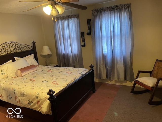 bedroom featuring ceiling fan and dark carpet