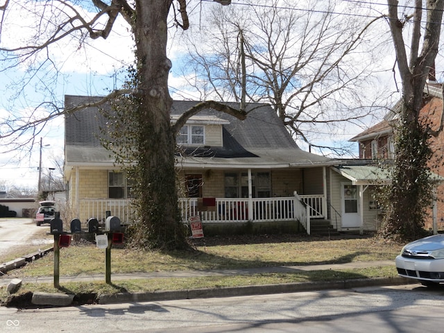 view of front of house featuring a porch and a shingled roof