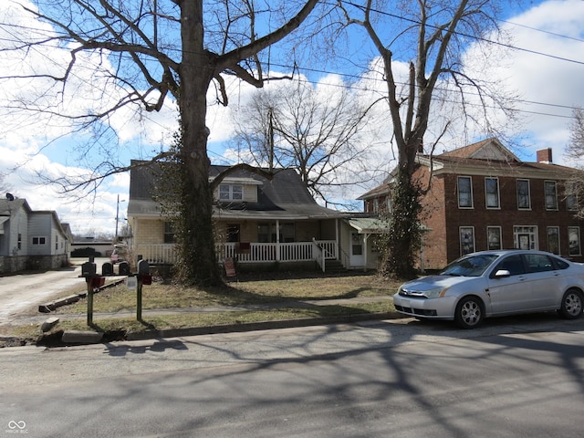 view of front of house with covered porch and brick siding