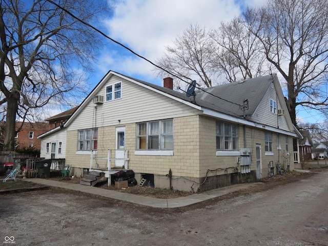 back of property with a chimney