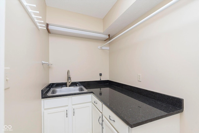 kitchen with a sink and white cabinets