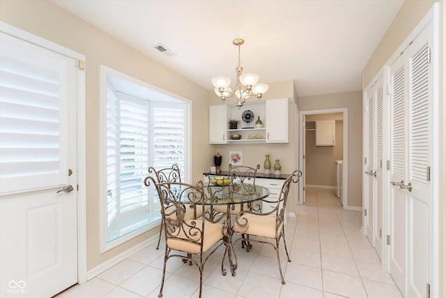 dining room featuring an inviting chandelier, light tile patterned floors, baseboards, and visible vents