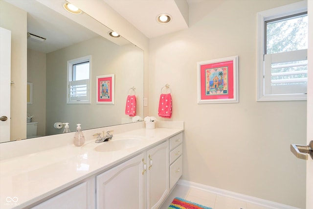 bathroom with baseboards, toilet, recessed lighting, tile patterned floors, and vanity