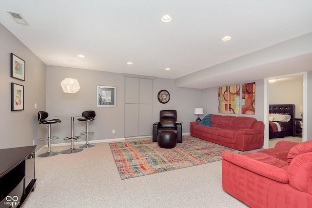 carpeted living area featuring visible vents, recessed lighting, and baseboards