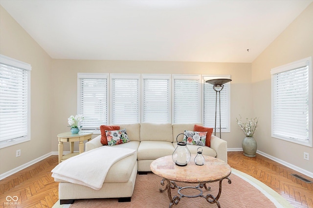 living room with visible vents, baseboards, and lofted ceiling