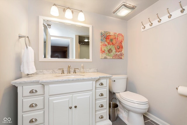 bathroom with toilet and vanity