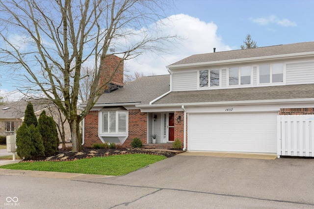 view of front of house with aphalt driveway, a shingled roof, a garage, brick siding, and a chimney