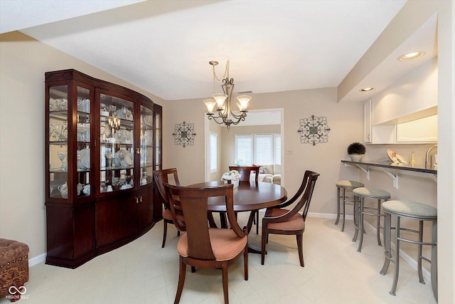 dining area with a notable chandelier, recessed lighting, and baseboards