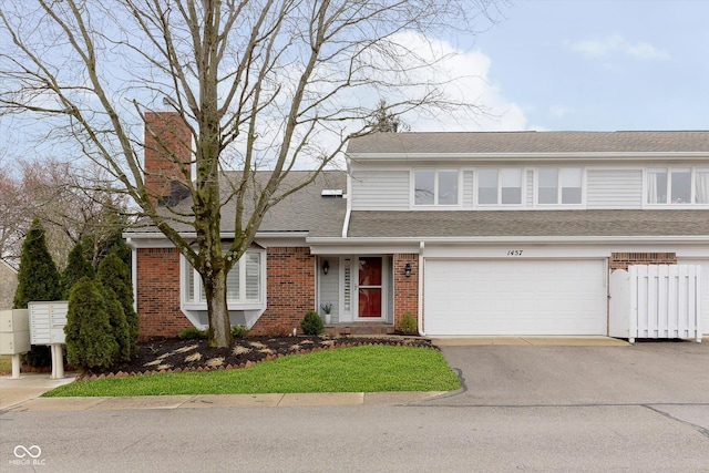 view of front of property with driveway, a shingled roof, a chimney, a garage, and brick siding