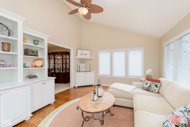 living room with high vaulted ceiling, a healthy amount of sunlight, and ceiling fan