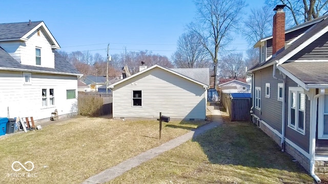 exterior space featuring a lawn, fence, and crawl space