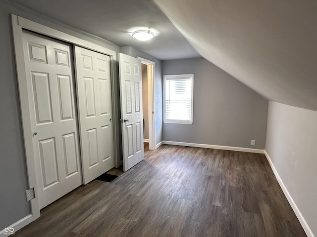 bonus room with lofted ceiling, baseboards, and dark wood-style flooring