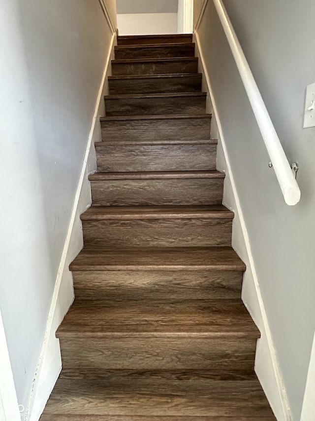 stairway featuring wood finished floors