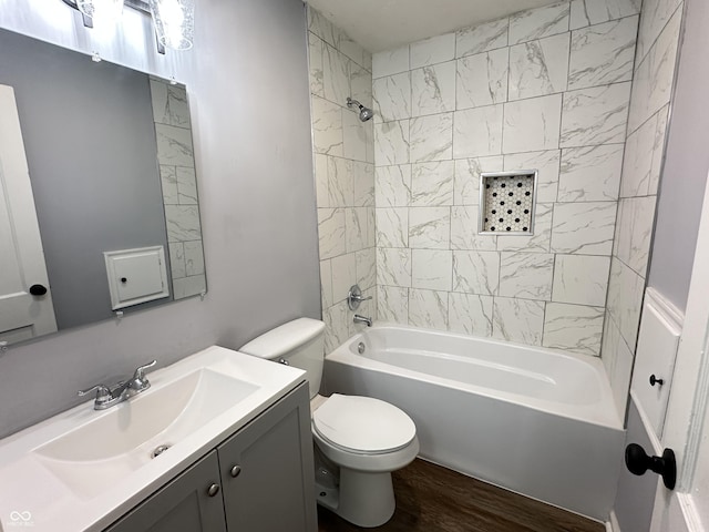 full bath featuring  shower combination, wood finished floors, vanity, and toilet