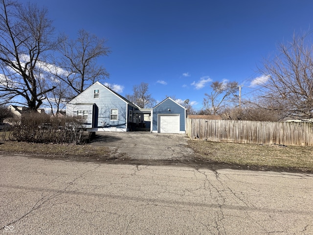 exterior space featuring driveway and fence