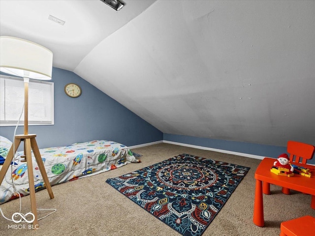 carpeted bedroom featuring vaulted ceiling and baseboards