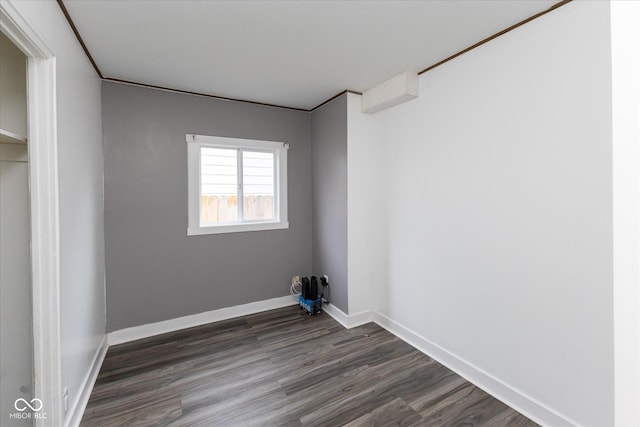 interior space with dark wood-style flooring and baseboards