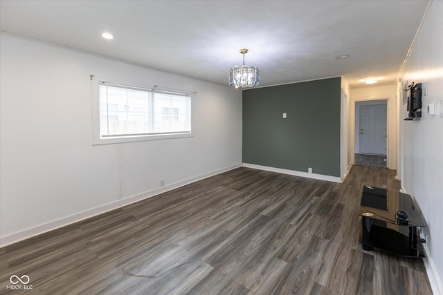 unfurnished living room featuring an inviting chandelier, baseboards, dark wood-style flooring, and recessed lighting