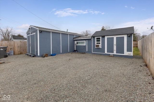 view of outbuilding with a fenced backyard and an outdoor structure