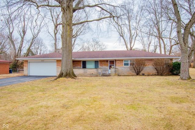 ranch-style house with a garage, brick siding, driveway, and a front lawn