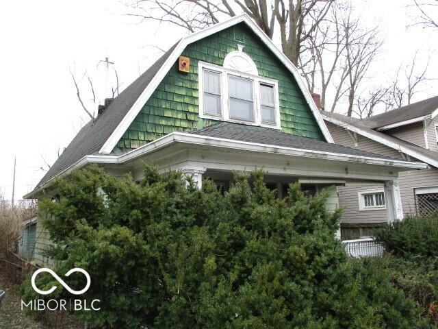 view of side of home with a gambrel roof