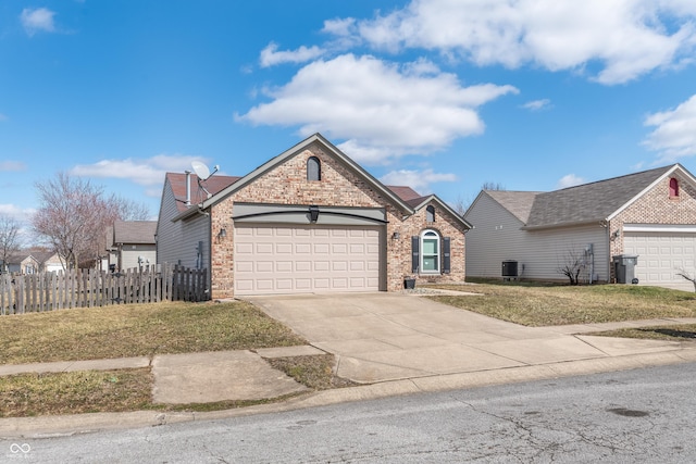 view of front facade featuring a garage, concrete driveway, brick siding, and fence