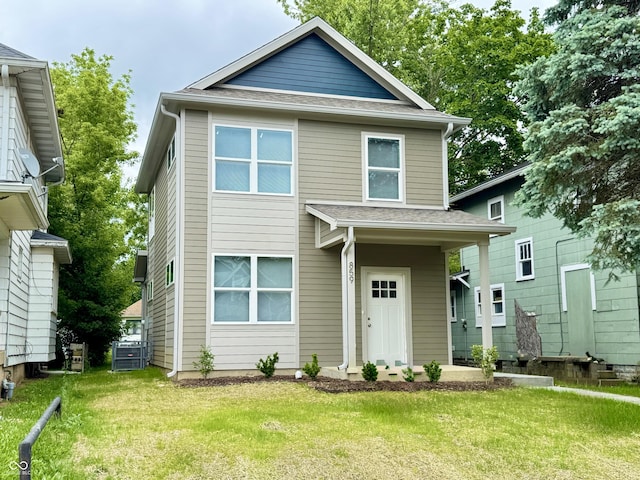 859 N Oakland Ave, Indianapolis, IN 46201 - view of front of house featuring a front yard, roof with shingles, and central AC unit