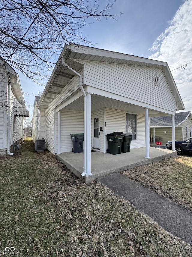 view of property exterior featuring a patio area, central AC, and a lawn