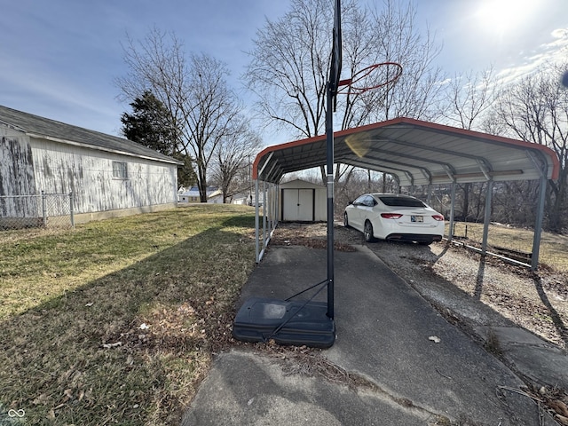 view of parking / parking lot with a detached carport, driveway, and a shed