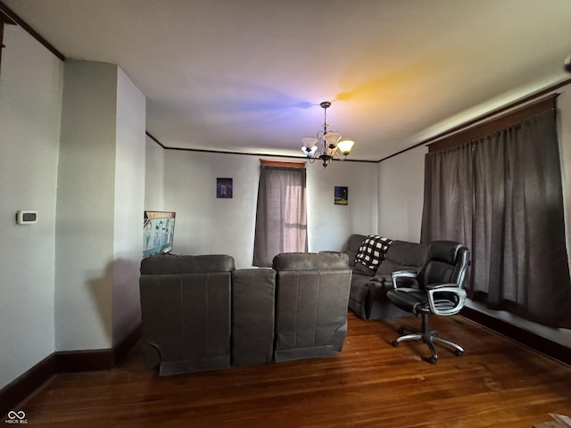 cinema with a notable chandelier, baseboards, and wood finished floors