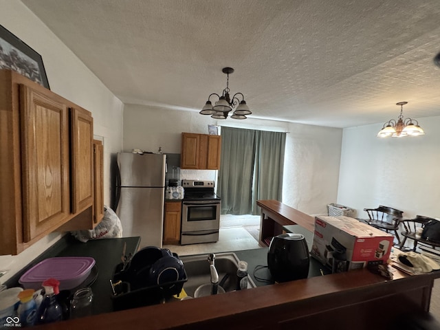 kitchen featuring stainless steel appliances, brown cabinets, decorative light fixtures, and an inviting chandelier